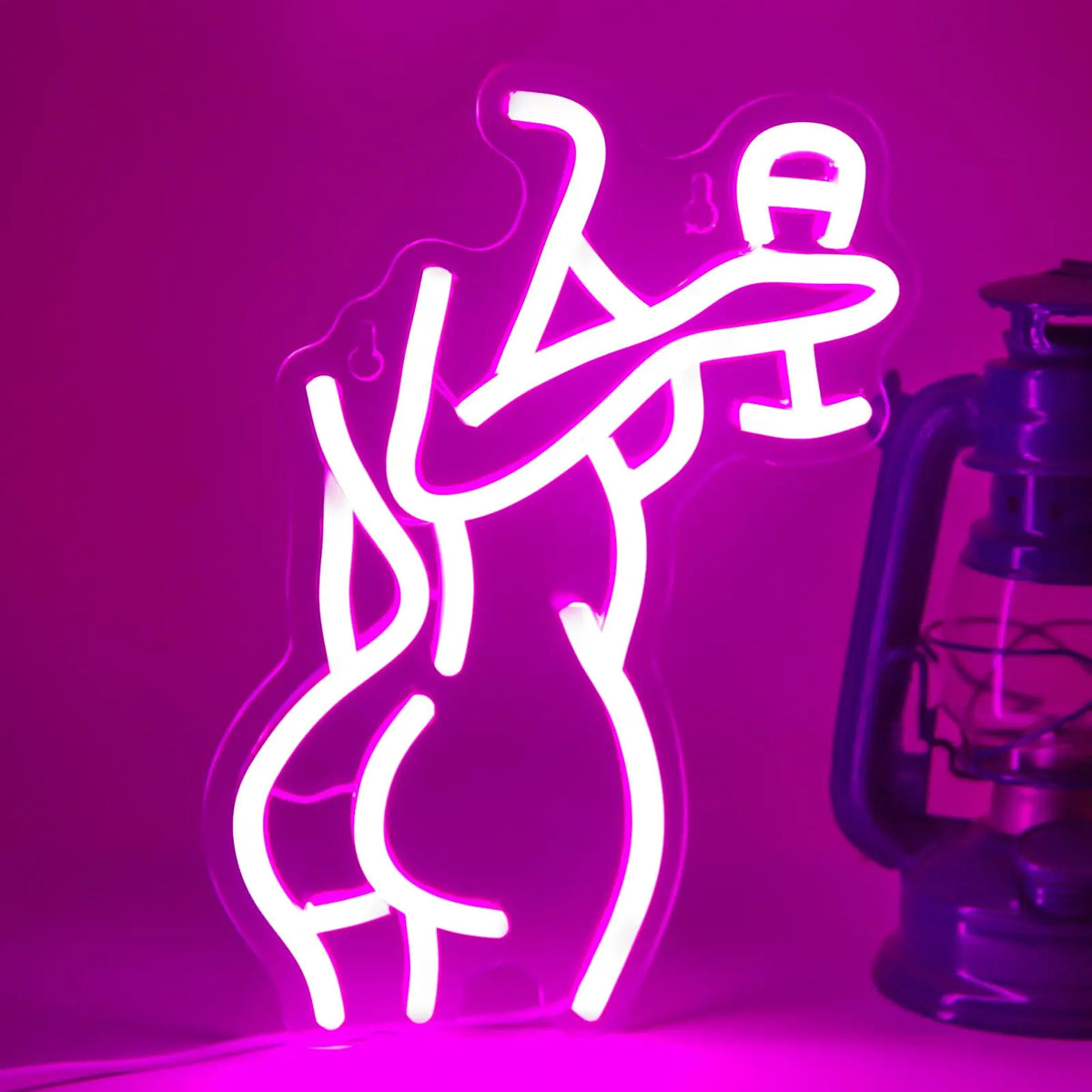A glowing neon silhouette of a female figure on a pink wall, illuminated by a USB light.