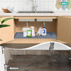 Before and after comparison of a flexible silicone under-sink mat with a raised edge in a kitchen sink.