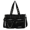 Black nylon shoulder bag with chain accents and multiple zippered pockets