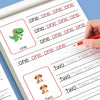 A close-up of a handwriting practice workbook showing tracing lines for numbers and letters.