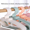 A collection of plastic hangers with bow designs in various pastel colors hanging on a wooden rack.