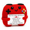 Red crochet animal doll shaped like a controller with a positive message card attached