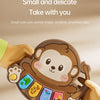 A small, brown animal-shaped finger piano toy is being held by a hand, showing its size and design.