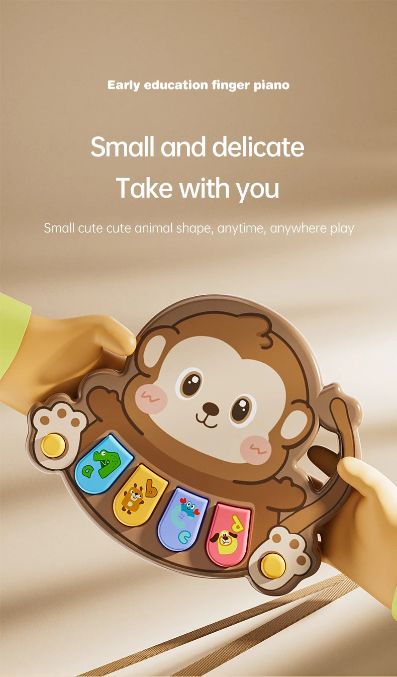 A small, brown animal-shaped finger piano toy is being held by a hand, showing its size and design.