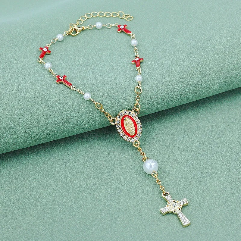 Gold rosary necklace with white pearls and red accents featuring a steering wheel pendant