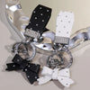 Silver and black PU leather bow keychain with an O-shaped buckle