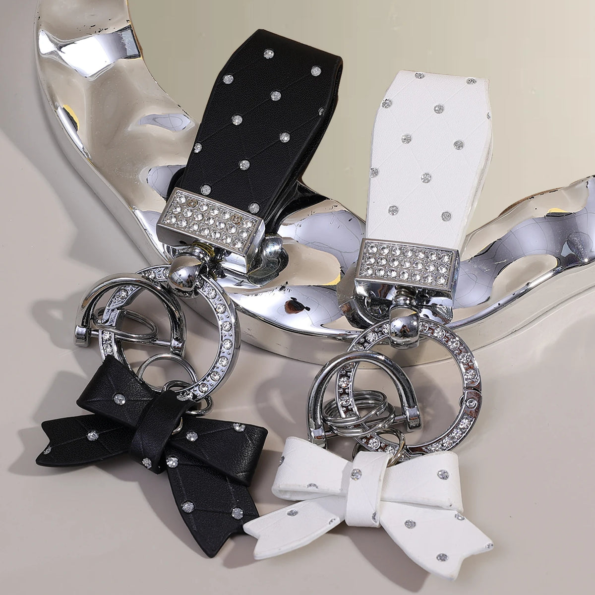 Silver and black PU leather bow keychain with an O-shaped buckle