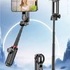 A black magnetic four-legged selfie stick with a smartphone mount and fill light attached, shown against a snowy landscape.