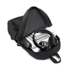 Black minimalist canvas backpack shown open, displaying a pair of black headphones.
