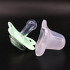 A silicone baby pacifier with a flower design and a protective cover shown against a dark background.
