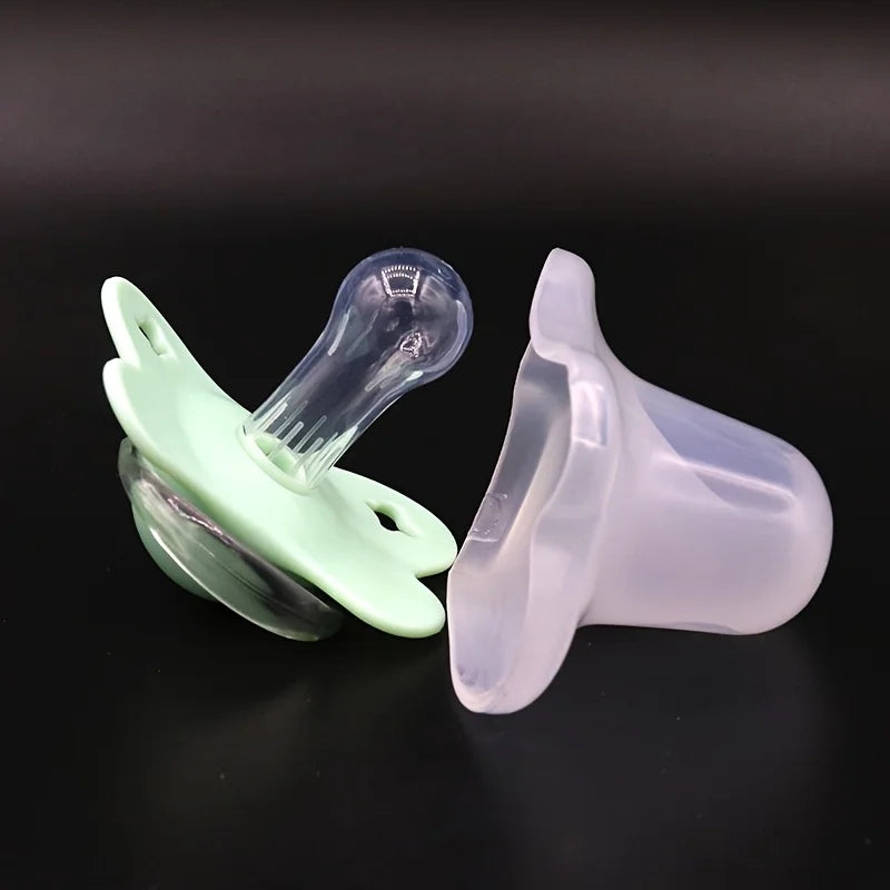 A silicone baby pacifier with a flower design and a protective cover shown against a dark background.