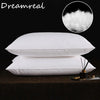A stack of white natural goose down feather sleeping pillows with a close-up of fluffy down