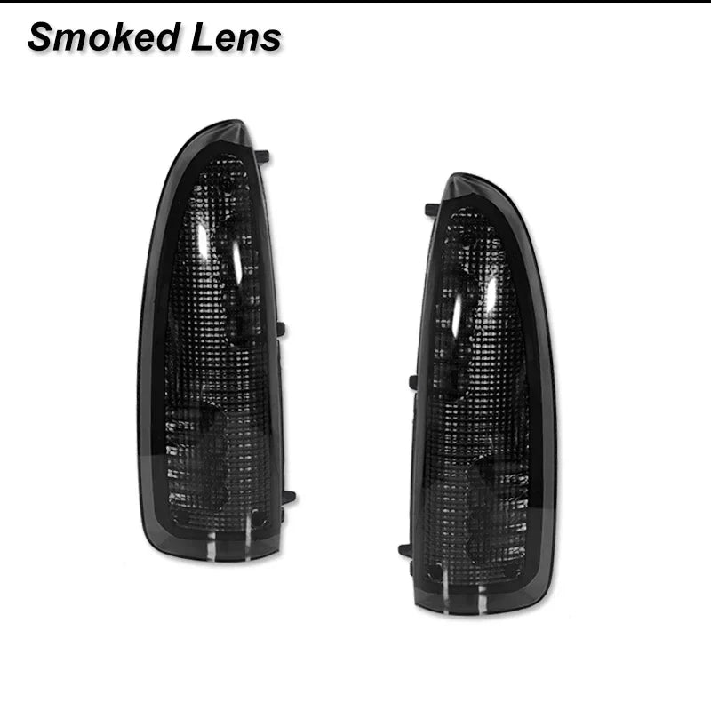 A pair of smoked lens amber LED side mirror turn signal lights for a Ford Super Duty or Excursion.