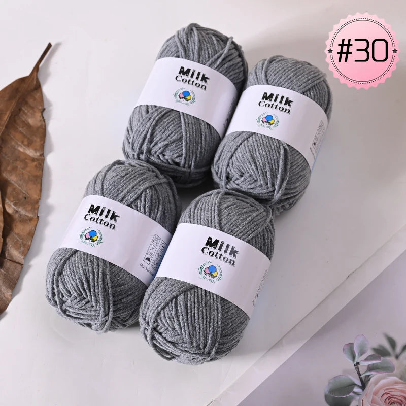 Three skeins of gray Milk Cotton yarn are displayed on a white surface, with a pink circle marked #30.