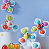 Three colorful spinning bath toys featuring sea creatures like a clownfish, a dolphin, and a bee.