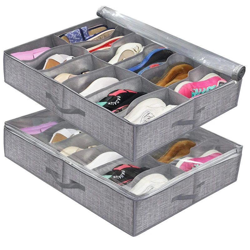 A gray under-bed shoe storage organizer with a clear window holding various pairs of shoes.
