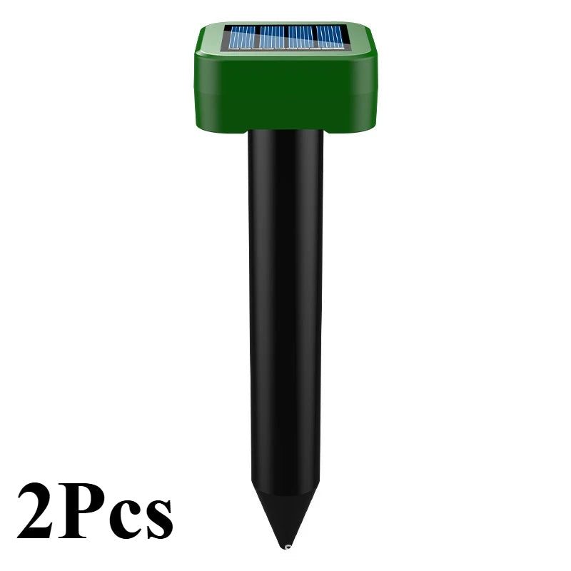 A green solar-powered ultrasonic animal repellent device with a black cylindrical body.