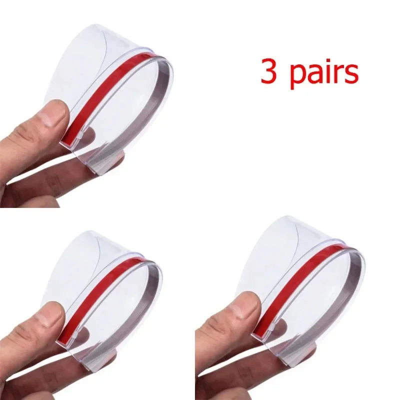 Three pairs of clear carbon fiber car side mirror rain and sun visors being held by a hand.