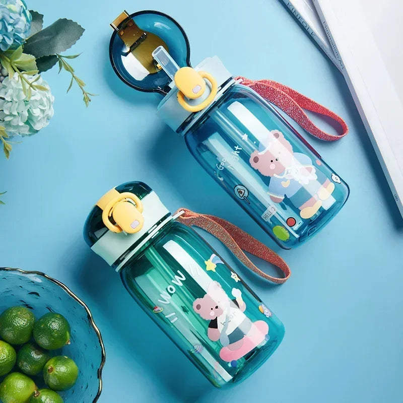 A collection of blue and pink cartoon-themed straw water bottles with leakproof lids resting on a light blue surface.