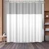 A white and gray waffle weave shower curtain with a geometric stripe pattern hanging from a metal rod.