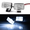 A pair of clear LED headlights and spotlights mounted for 1/10 RC crawler trucks