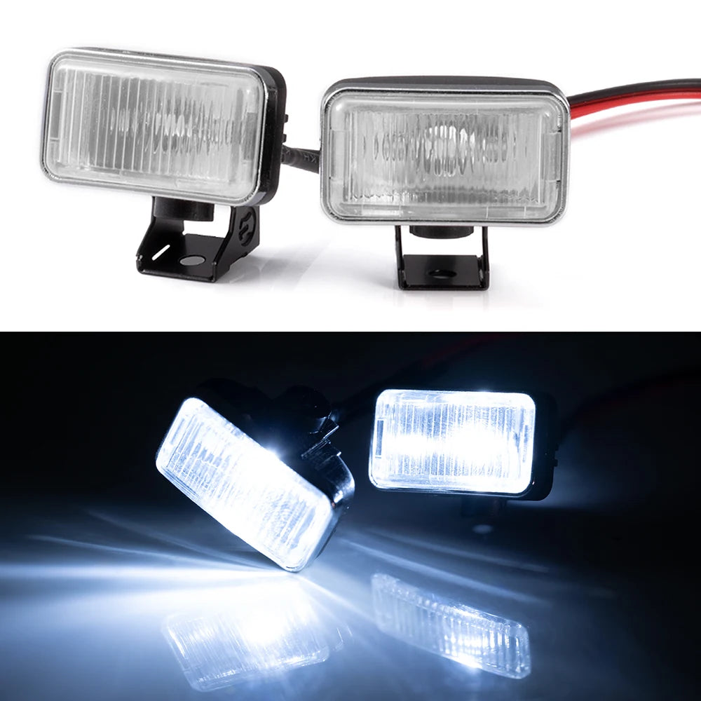A pair of clear LED headlights and spotlights mounted for 1/10 RC crawler trucks