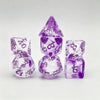 A set of seven purple polyhedral gaming dice, including a pyramid shape and various numbered dice.
