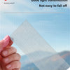 A hand holds a piece of mesh fiberglass screen repair tape demonstrating good light transmission and durability.
