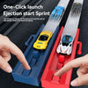 A hand is launching a yellow die-cast racing car on a blue track, demonstrating the one-click ejection start sprint feature.