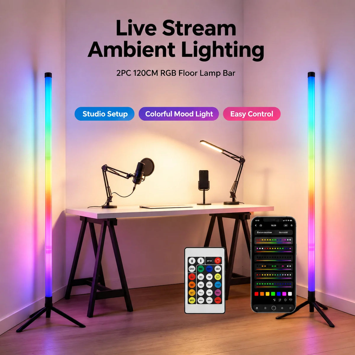 Two vertical RGB LED floor lamps are displayed on a desk with a laptop and control panel.