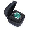 Black portable leather watch travel case with soft lining open displaying a green digital watch