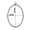 A round wooden embroidery hoop with a 19cm diameter and 27cm height, featuring a metal hook for use in cross-stitch or needle