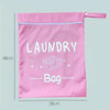 A pink portable waterproof laundry bag with a zipper and a label reading Laundry Bag