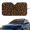 Leopard print car windshield sunshade covering the front glass of a blue car.
