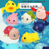 A collection of colorful bath toys featuring cartoon turtles, ducks, and whales floating in water.