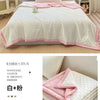 White waffle-weave quilt with pink trim and matching bedding set