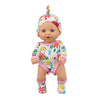 A baby doll wearing a floral jumpsuit outfit and matching headscarf.