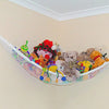 A large mesh toy storage hammock filled with various stuffed toys and plush animals mounted on a wall.