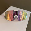 A pair of polarized sunglasses with a multi-colored, iridescent lens resting on a white surface.
