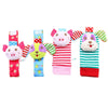 A set of soft baby rattles featuring pink and white plush toys attached to wrist and foot finders.