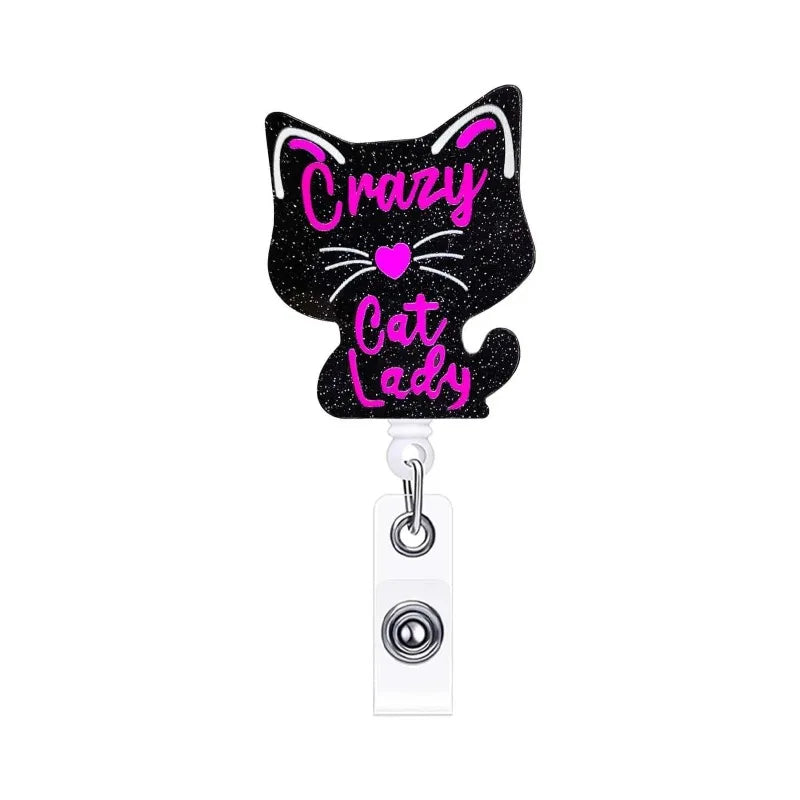 A black glitter acrylic badge reel featuring a cat lady design with pink text.