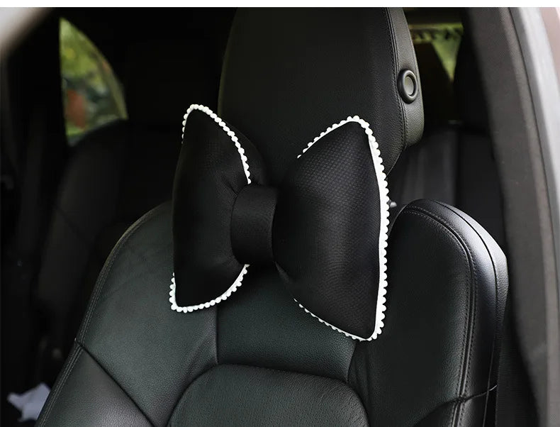 Black silky bow car headrest pillow with white trim and waist cushion set.