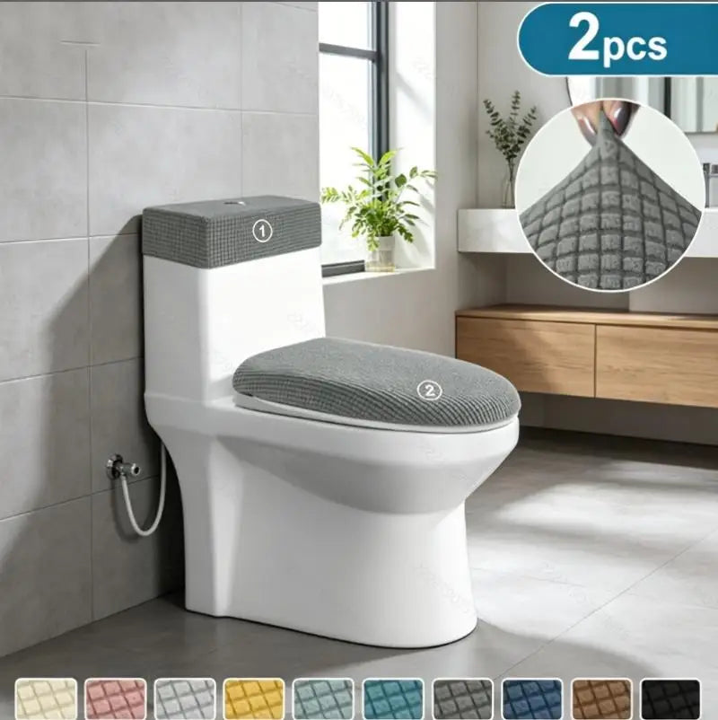A white toilet with a gray fleece seat cover and matching lid and tank covers displayed in a bathroom setting.