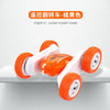 An orange and white remote control stunt car with four wheels is shown on a white surface.