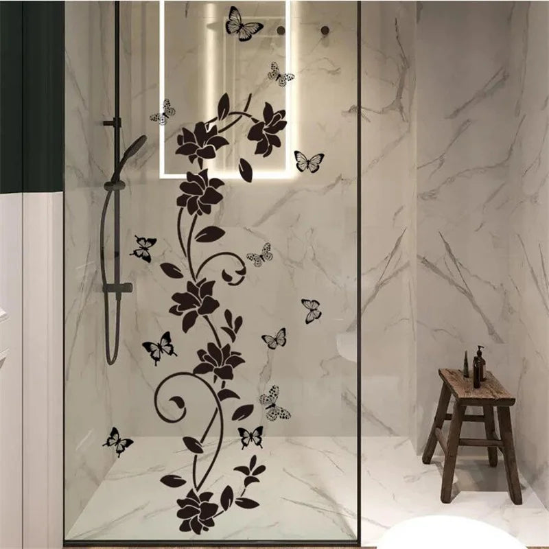 A vertical glass panel features a black floral vine design with butterfly silhouettes on a marble background.