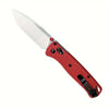 A compact folding knife with a silver blade and a red nylon fiber handle shown from the side.