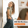 A woman is reflected in a full-length mirror, showing an HD reflection without distortion.