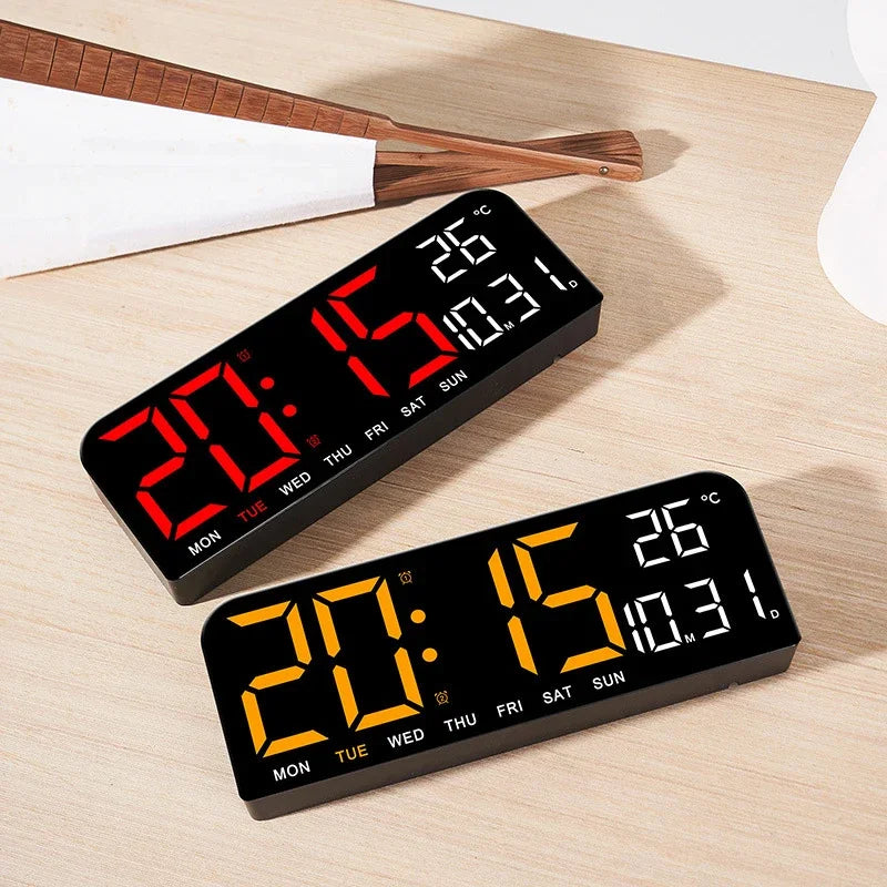 A black LED digital wall clock displaying the time 20:15 and temperature 26 degrees Celsius on a wooden surface.