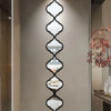 Moroccan-inspired decorative mirror wall stickers featuring a vertical, diamond-shaped pattern on a light gray wall.