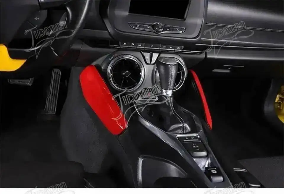 Interior view of a car's gear shift and surrounding trim components with red accents.